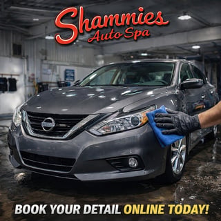 Gray Nissan sedan being hand-washed at Shammies Auto Spa with neon sign and text reading Book Your Detail Online Today